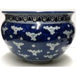 A LARGE 19TH CENTURY CHINESE BOWL Decorated with prunus on a blue ground. (diameter 34cm x h 22cm)