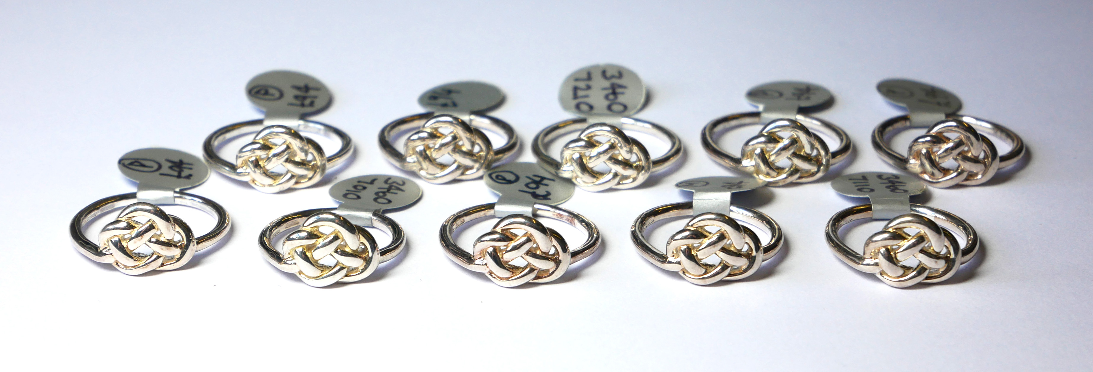 TEN SILVER .925 LOVE KNOT RINGS.