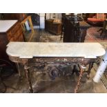 A 19TH CENTURY CONSOLE TABLE With breakfront white marble top, supported on distressed gilt and