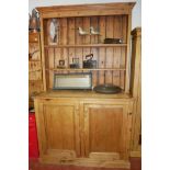 A 19TH CENTURY AND LATER PINE DRESSER With open shelves above cupboards. (127cm x 59cm x 217cm)