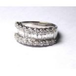 AN 18CT WHITE GOLD AND DIAMOND BAND RING An arrangement of baguette cut stones with two rows of