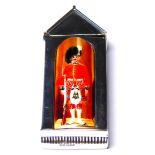 AN UNUSUAL STERLING SILVER AND ENAMEL VESTA CASE Formed as a sentry box with enamel Royal Guard