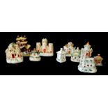 A COLLECTION OF TEN 19th CENTURY STAFFORDSHIRE POTTERY COTTAGES, comprising of a castle form spill