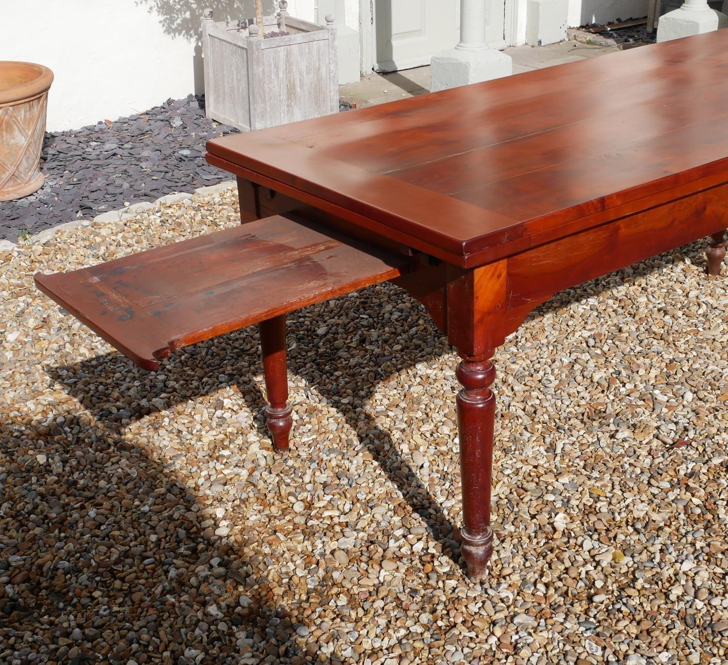 AN EARLY 20TH CENTURY FRENCH SOID CHERRYWOOD FOUR PLANK TOP DRAW LEAF TABLE With a single drawer and - Image 2 of 5