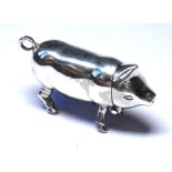 A STERLING SILVER PIG FORM VESTA CASE Having a hinged head and strike to base, marked 'Sterling'. (