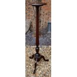 A 19TH CENTURY MAHOGANY TORCHÈRE The circular top raised on a turned reeded column on three