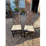 A PAIR OF LATE VICTORIAN OAK CAROLEAN STYLE STANDARD CHAIRS Along with an early 20th Century