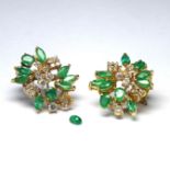 A PAIR OF 14CT GOLD, EMERALD AND DIAMOND CLIP EARRINGS The arrangement of emeralds interspersed with