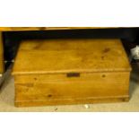 A 19TH CENTURY WAXED PINE CHEST With rising hinged lid, brass escutcheon and steel loop carry