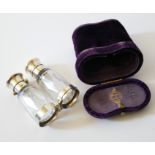 A CASED VICTORIAN WHITE METAL AND CUT GLASS FOLDING DOUBLE SCENT BOTTLE Screw, flip caps and faceted
