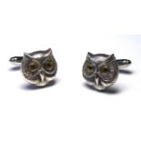 A PAIR OF SILVER OWL MASK FORM CUFFLINKS Set with glass eyes. (approx 1.5cm)