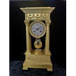 A LARGE EARLY 19th CENTURY FRENCH GILT MÉTAL PORTICO CLOCK, having four classical column supports,