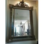 A 19TH CENTURY ITALIAN GILT FRAMED MIRROR The foliage cartouche above sectional glass bevelled