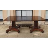 A REGENCY PERIOD TWIN PEDESTAL DINING TABLE Having two solid flame mahogany tops supported by shaped