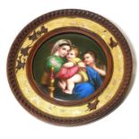 FOLLOWER OF RAPHAEL, A 19TH CENTURY PORCELAIN ROUNDEL Parcel gilt framed. (diameter 18cm)