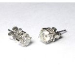 A PAIR OF 18CT WHITE GOLD AND DIAMOND STUD EARRINGS, A single round cut diamond Approx 1.27ct