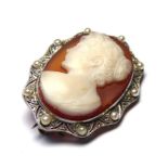 A 20TH CENTURY YELLOW METAL DIAMOND AND SEED PEARL CAMEO BROOCH The scrolled pierced frame set