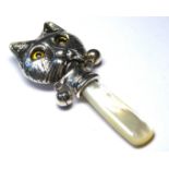 A STERLING SILVER AND MOTHER OF PEARL CAT FORM BABIES RATTLE Set with glass eyes and bells,