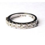 AN 18CT WHITE GOLD AND DIAMOND HALF ETERNITY RING A row of nine round cut diamonds Size Approx 0.