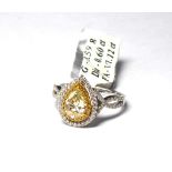 AN 18CT GOLD AND 1.12CT PEAR CUT DIAMOND AND FANCY DIAMOND RING A single pear cut diamond edged with