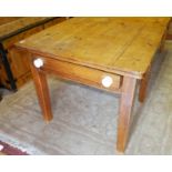 A 20TH CENTURY PINE KITCHEN TABLE The single drawer applied with porcelain handles, raised on square