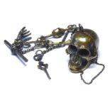 A BRASS SKULL FORM SNUFF BOX AND MATCHING ALBERT CHAIN The chain set with skull form link with T bar