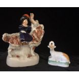 A 19th CENTURY STAFFORDSHIRE POTTERY FIGURE,A young girl riding a goat ,together with a recumbent