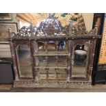 A VENETIAN DESIGN WALL MOUNTED MIRRORED BACK CABINET With pierced floral fretwork pediment above