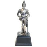 A 20th CENTURY SILVER STATUE OF A BRITISH CAVALRY SOLDIER, in standing pose and raised on an