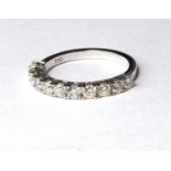 AN 18CT WHITE GOKD AND DIAMOND HALF ETERNITY RING A row of eleven round cut diamonds Size M Approx