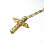 A 14CT GOLD AND DIAMOND CRUCIFIX NECKLACE Round cut diamonds on a fine link chain Approx 2ct total