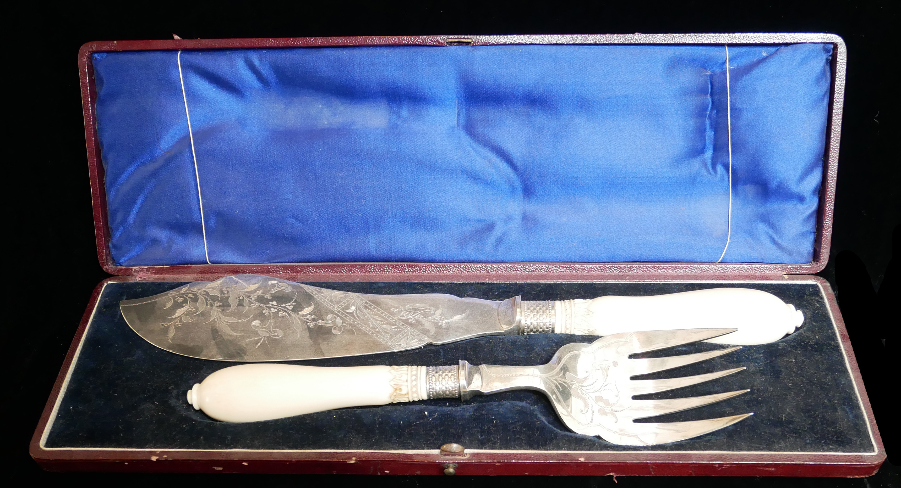 A CASED PAIR OF VICTORIAN SILVER PLATE AND IVORY FISH SERVERS Aesthetic form with engraved floral