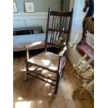 A 19TH CENTURY BOBBIN TURNED ROCKING CHAIR With seagrass seat.