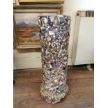 A VICTORIAN DRAIN PIPE NOW STICK STAND Later mosaic clad with pottery fragments. (64cm)
