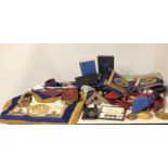 A COLLECTION OF MASONS REGALIA Including gilt medallions, aprons, sashes cuffs and books.