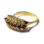 A VINTAGE 18CT GOLD, DIAMOND AND RUBY RING Having a single row of round cut rubies with two rows