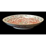 AN 18TH/19TH CENTURY CHINESE SHALLOW BOWL Decorated with dragons amongst clouds, peaches contained