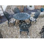 A VICTORIAN STYLE CAST ALUMINIUM CIRCULAR GARDEN TABLE AND FOUR CHAIRS.