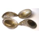 A PAIR OF VICTORIAN SILVER SERVING SPOONS, having a scrolled and pierced design. Hallmarked Harrison