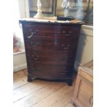 MAPLE & CO., A MAHOGANY BOW FRONT CHEST OF DRAWERS The four long graduated drawers applied with swan