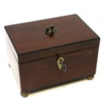 A GEORGIAN MAHOGANY AND LINE INLAID TEA CADDY With ivory escutcheon standing on four brass feet.