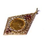 A VICTORIAN 22CT GOLD SOVEREIGN COIN IN A 9CT GOLD AND GARNET SET PENDANT MOUNT The 1875 young Queen