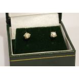 A PAIR OF 18CT GOLD AND DIAMOND STUD EARRINGS Each set with a round cut diamond. (approx total