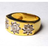 AN 18CT GOLD AND DIAMOND THREE STONE GENTS SIGNET RING Round cut diamonds in a star design
