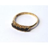 A VINTAGE 9CT GOLD AND SAPPHIRE FIVE STONE RING Having a row of round cut stones (size P/Q). (approx