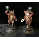 A PAIR OF COLD PAINTED BRONZE FIGURAL CANDLESTICKS, IN THE FORM OF GAMBLING FOXES. (17cm)