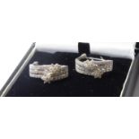 A PAIR OF 14CT WHITE GOLD AND DIAMOND EARRINGS Two clusters of diamonds on page set bands with