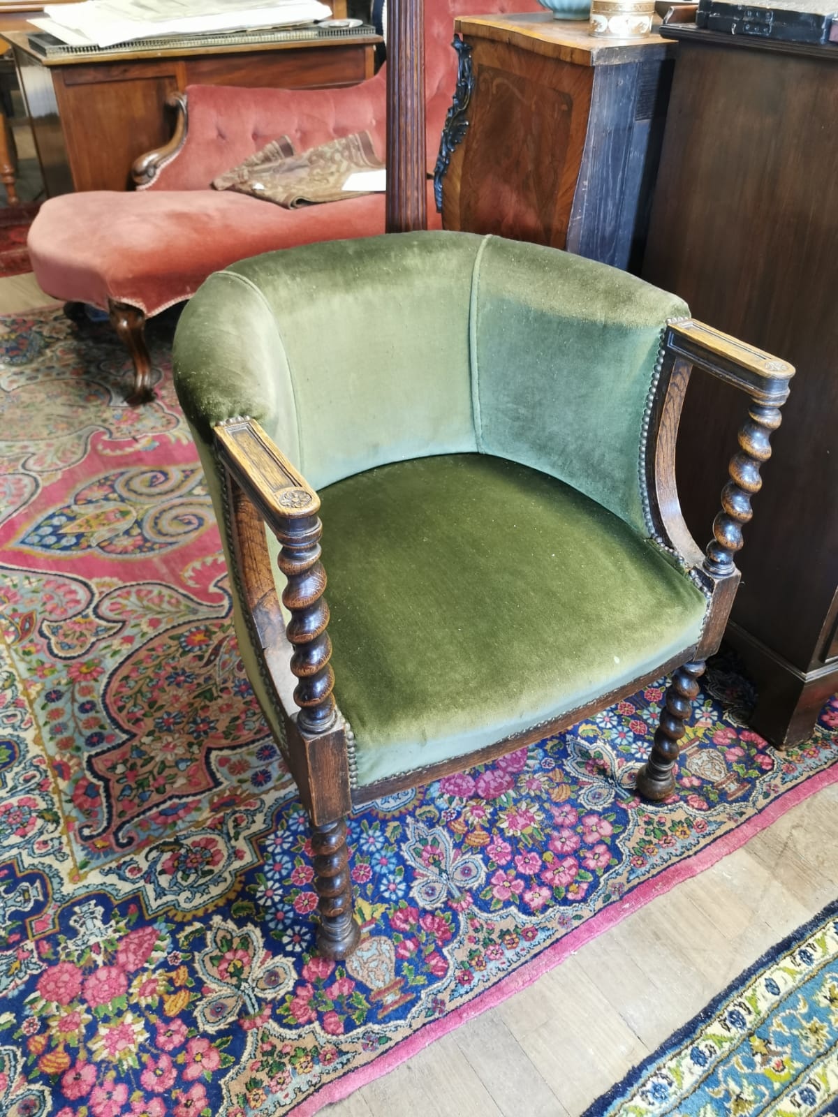A SOLID OAK AND VELVET UPHOLSTERED TUB CHAIR On barley twist supports. (w 63cm x depth 64cm x 74cm)
