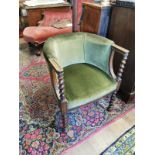 A SOLID OAK AND VELVET UPHOLSTERED TUB CHAIR On barley twist supports. (w 63cm x depth 64cm x 74cm)