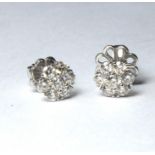 A PAIR OF 18CT WHITE AND DIAMOND DAISY CLUSTER EARRINGS, An arrangement of round cut stones Approx